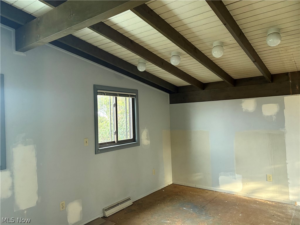 5276 Rome Rock Creek Road Rome, OH 44085 - Photo 8 of 10 Empty room featuring vaulted ceiling with beams and a baseboard heating unit