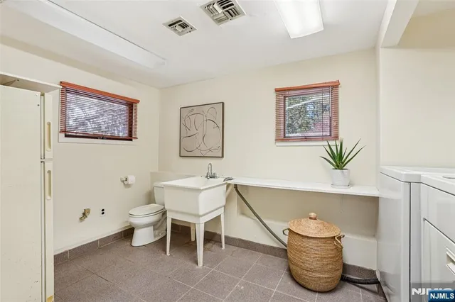 a living room with furniture and a wall painting