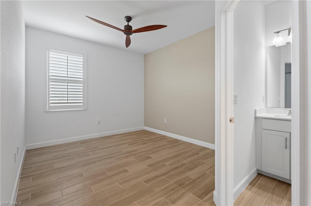 1779 Hagen Court Naples, FL 34120 - Photo 11 of 36 a view of an empty room with wooden floor and a window
