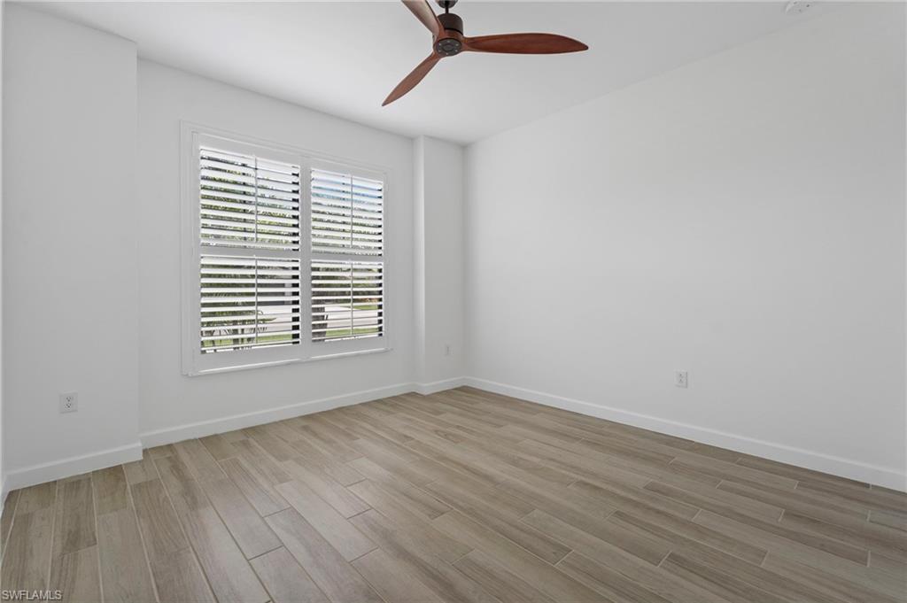 1779 Hagen Court Naples, FL 34120 - Photo 14 of 36 a view of an empty room with wooden floor and a window