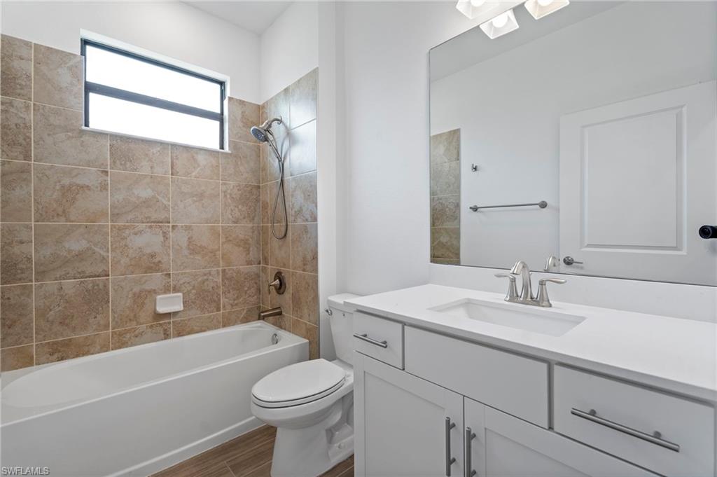 1779 Hagen Court Naples, FL 34120 - Photo 16 of 36 a bathroom with a sink a toilet and bathtub
