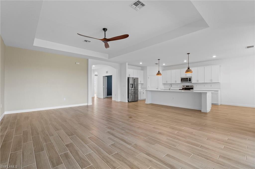 1779 Hagen Court Naples, FL 34120 - Photo 29 of 36 a view of an empty room with kitchen appliances and a window