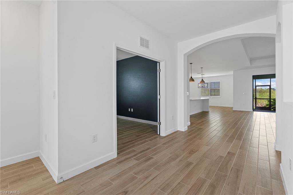 1779 Hagen Court Naples, FL 34120 - Photo 31 of 36 a view of a hallway with wooden floor