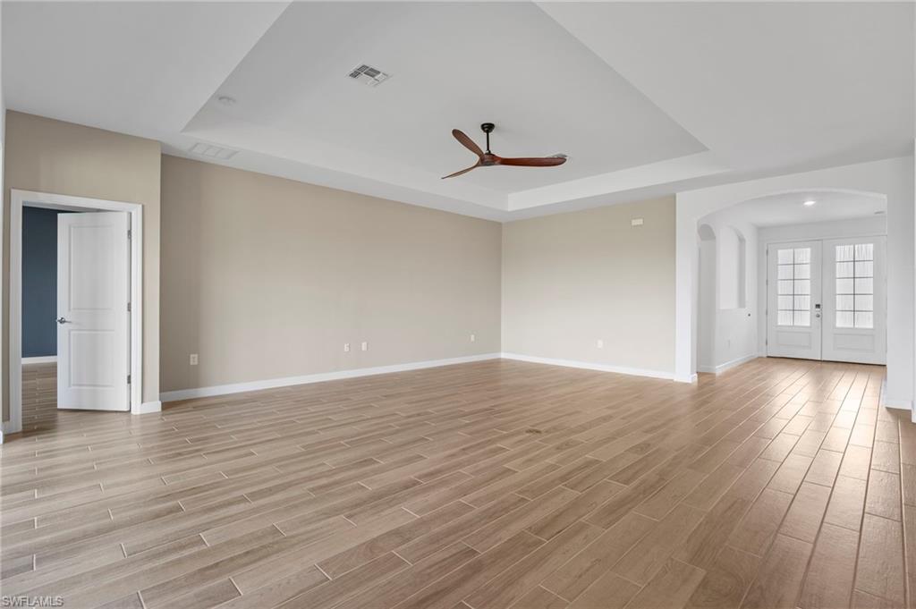 1779 Hagen Court Naples, FL 34120 - Photo 5 of 36 a view of an empty room with wooden floor and a window