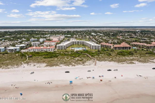 an aerial view of residential houses with outdoor space