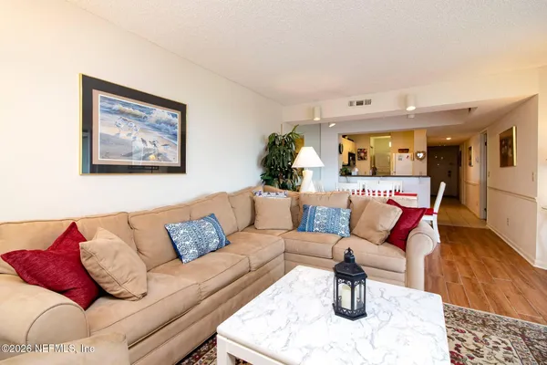 a living room with furniture and kitchen view