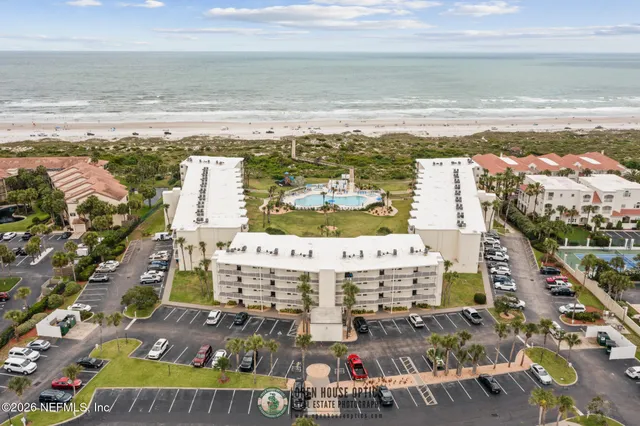 an aerial view of a swimming pool and ocean view