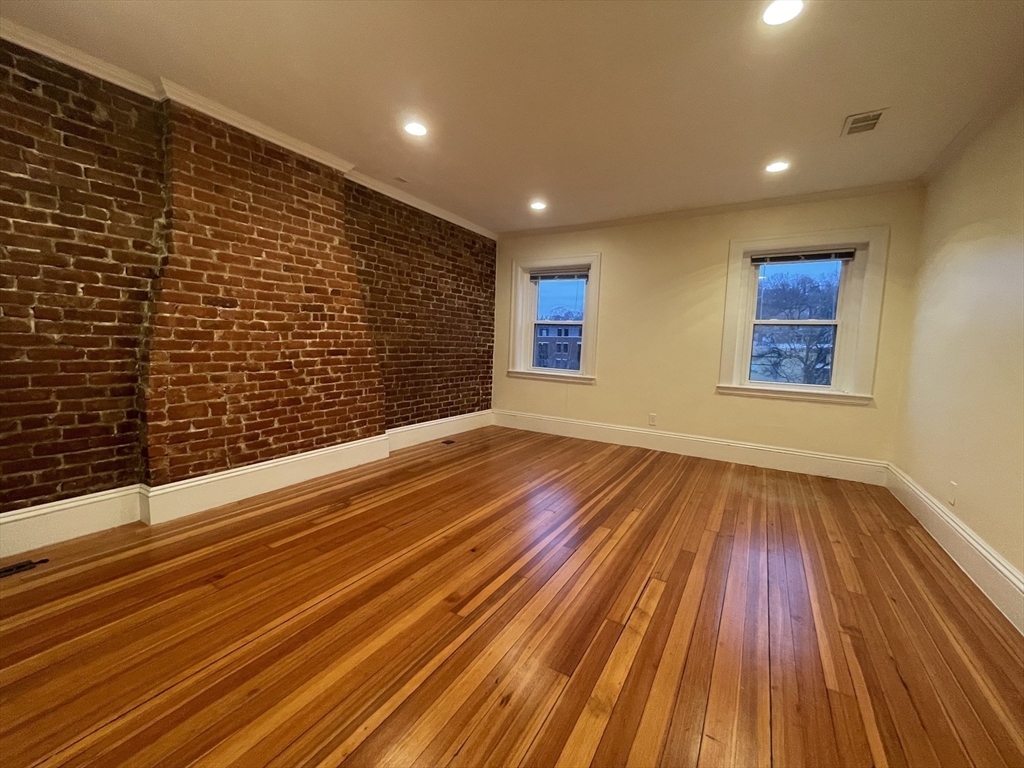1616 Beacon Street, Unit 3 Brookline, MA 02446 - Photo 13 of 17 a view of an empty room with wooden floor and a window