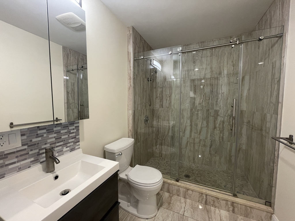 1616 Beacon Street, Unit 3 Brookline, MA 02446 - Photo 8 of 17 a bathroom with a sink toilet and shower