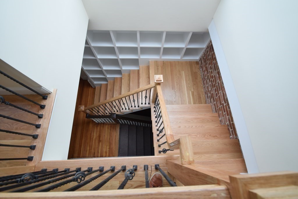 1616 Beacon Street, Unit 3 Brookline, MA 02446 - Photo 9 of 17 a view of staircase with white walls and a window