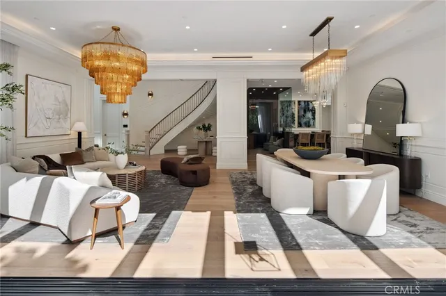 a view of a dining room with furniture chandelier and wooden floor