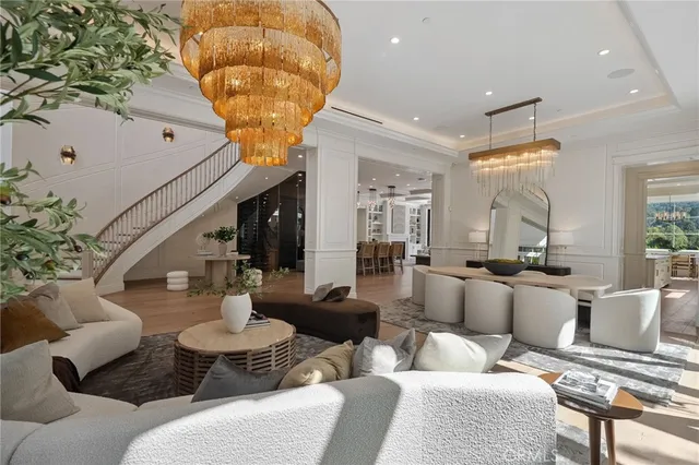 a living room with fireplace furniture and a large window