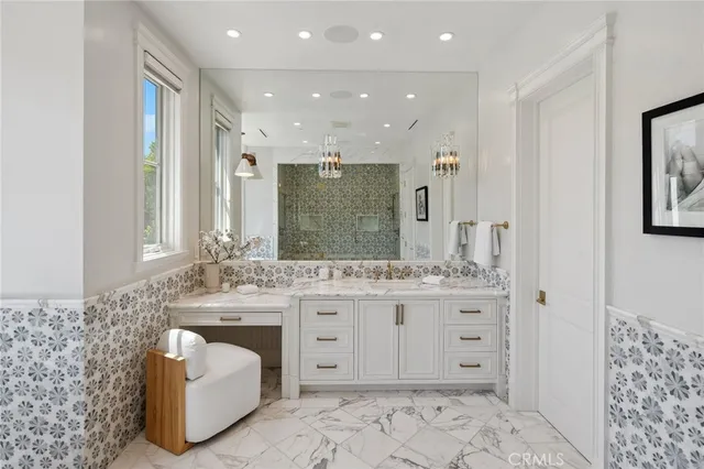 a kitchen with stainless steel appliances granite countertop a sink a stove and a wooden cabinets