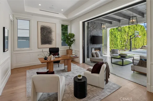 a view of a dining room with furniture a chandelier and kitchen view