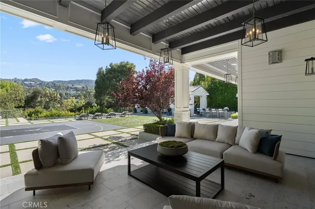 a dining room with furniture a kitchen and chandelier