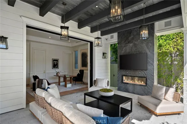 a front view of a house with swimming pool and sitting area