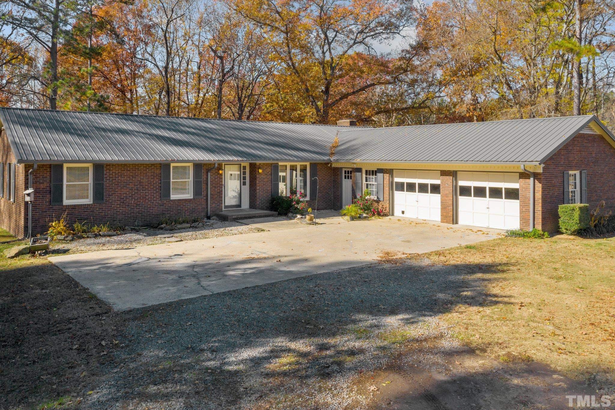 1275 Spring Valley Lake Road Henderson, NC 27537 - Photo 2 of 30 a front view of house with yard and trees around