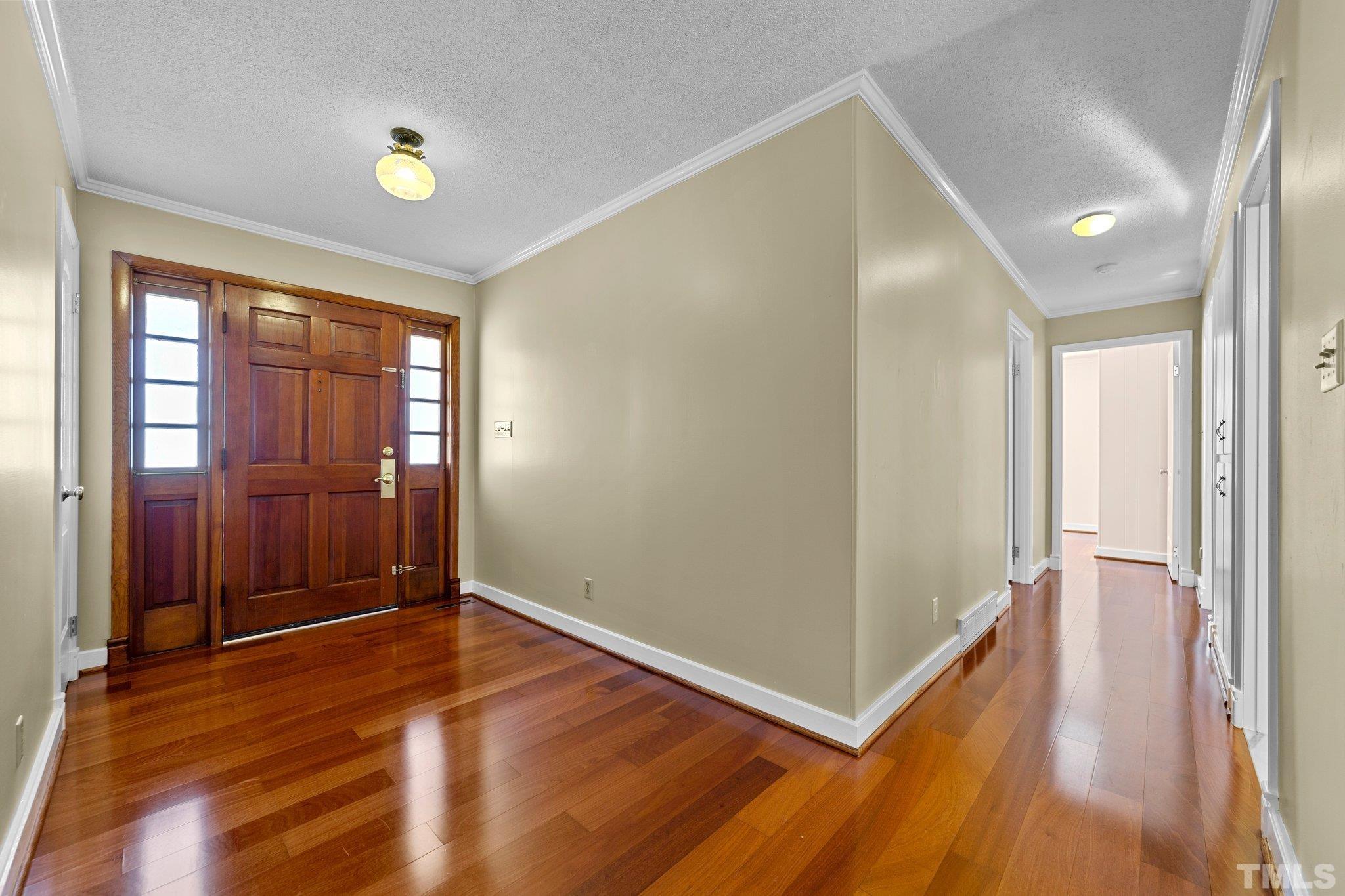 1275 Spring Valley Lake Road Henderson, NC 27537 - Photo 11 of 30 an empty room with wooden floor and windows