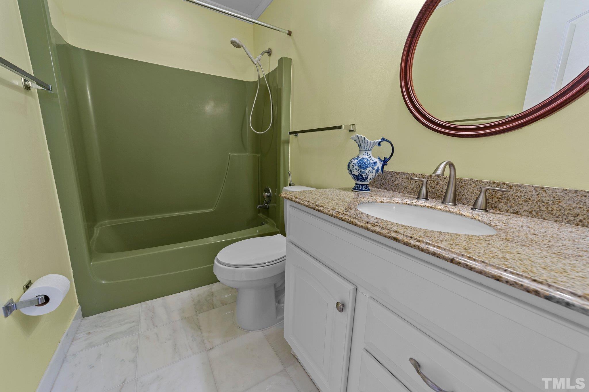 1275 Spring Valley Lake Road Henderson, NC 27537 - Photo 13 of 30 a bathroom with a granite countertop toilet sink and mirror