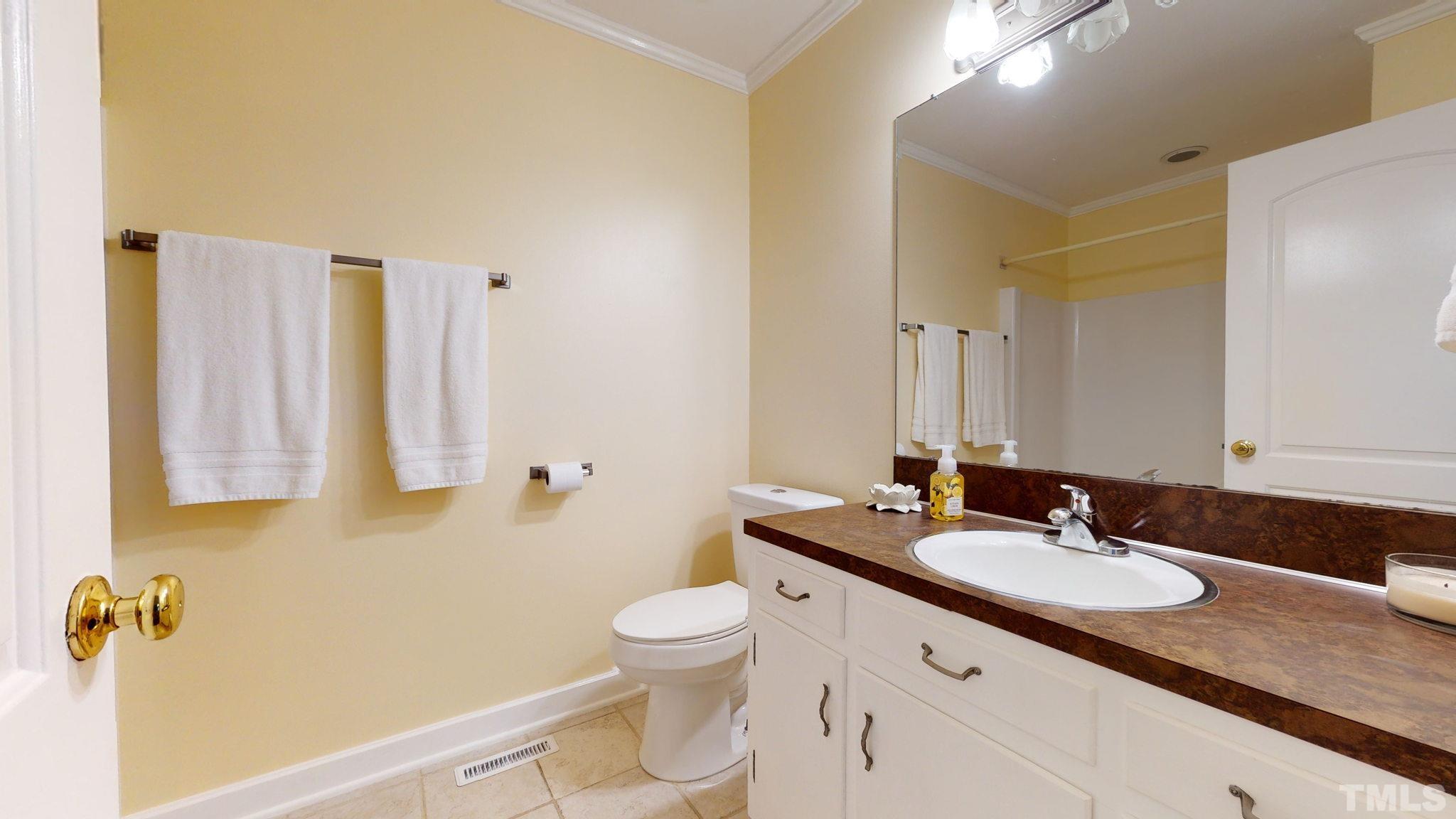 1275 Spring Valley Lake Road Henderson, NC 27537 - Photo 15 of 30 a bathroom with a granite countertop sink toilet and a mirror