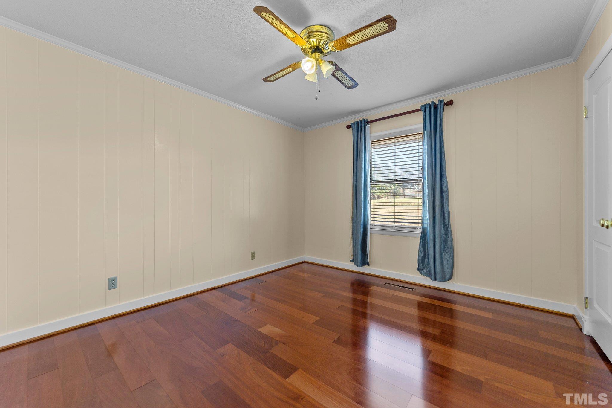 1275 Spring Valley Lake Road Henderson, NC 27537 - Photo 16 of 30 wooden floor in an empty room with a window