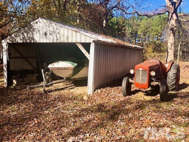 1275 Spring Valley Lake Road Henderson, NC 27537 - Photo 24 of 30 a backyard of a house with table and chairs