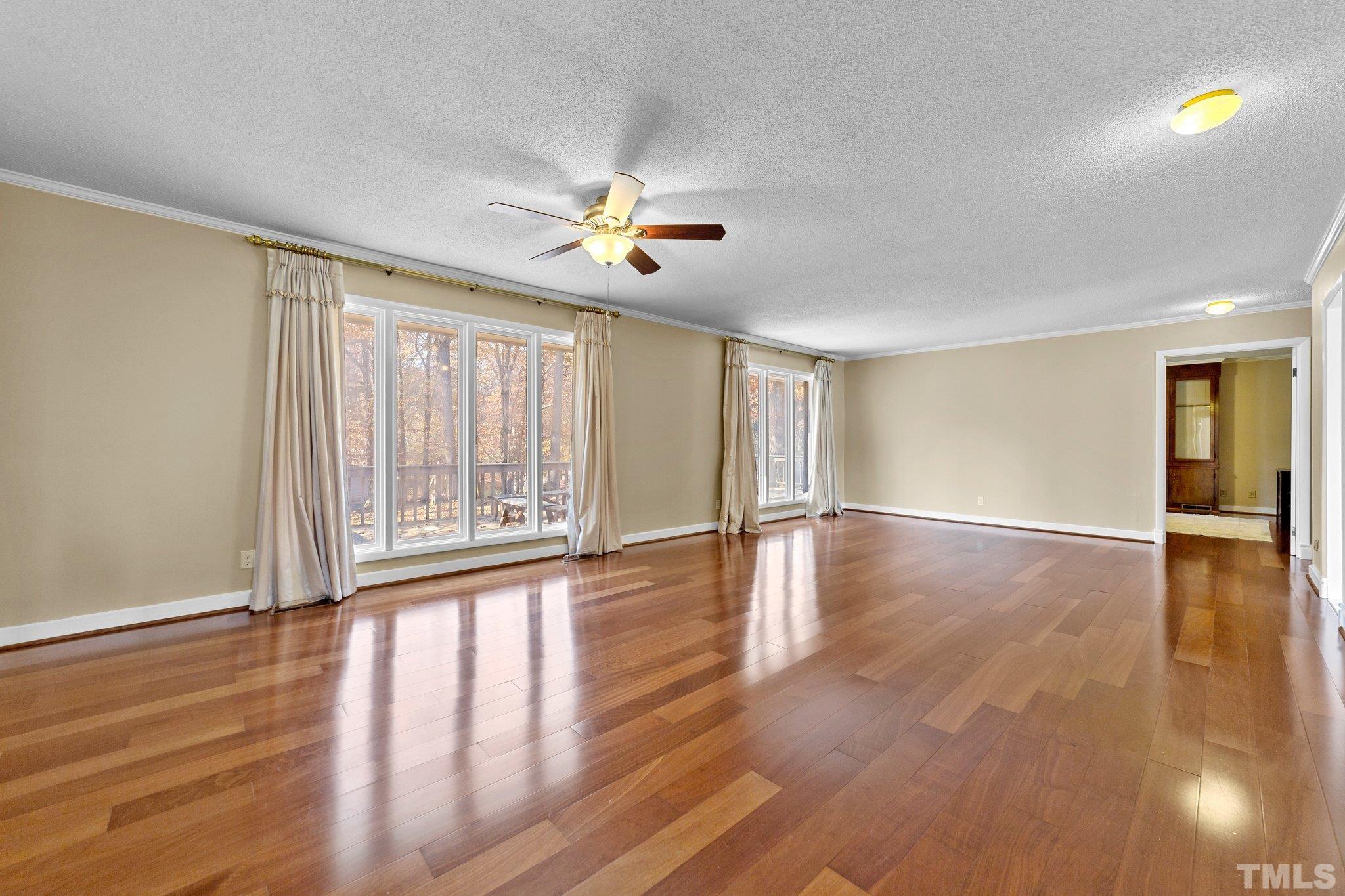 1275 Spring Valley Lake Road Henderson, NC 27537 - Photo 5 of 30 wooden floor in an empty room with a window