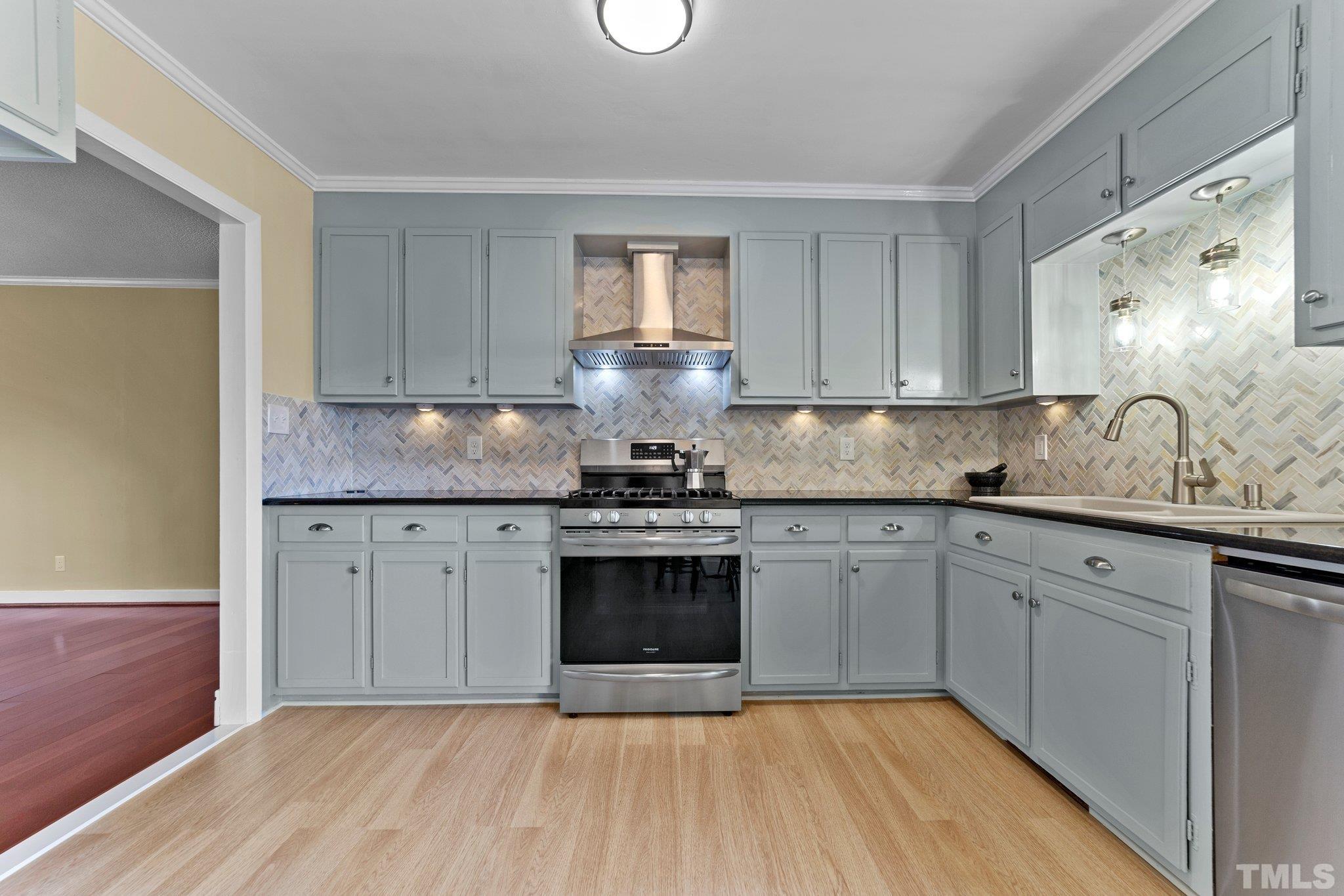 1275 Spring Valley Lake Road Henderson, NC 27537 - Photo 7 of 30 a kitchen with granite countertop stainless steel appliances a sink stove and cabinets