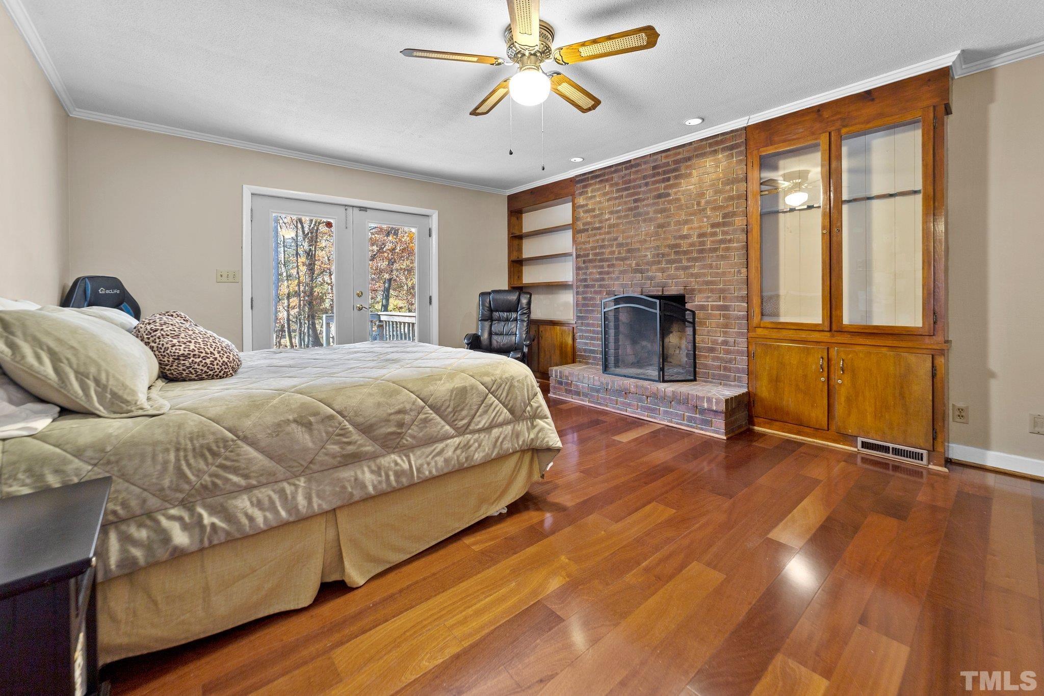 1275 Spring Valley Lake Road Henderson, NC 27537 - Photo 10 of 30 a spacious bedroom with a bed and a fireplace