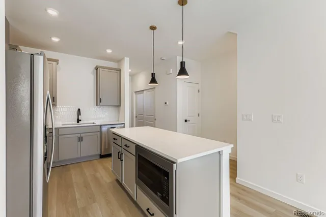 a bedroom with a bed lamp and windows