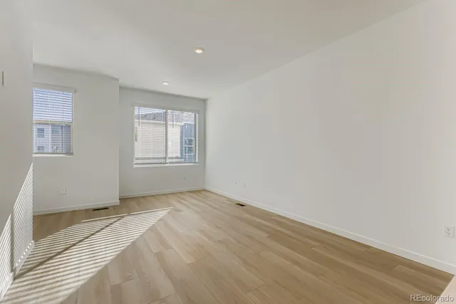 a view of a bedroom with cabinet and windows