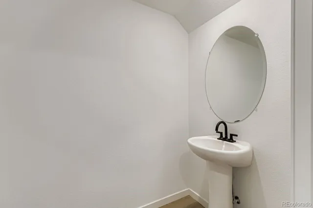 a view of a kitchen with a sink and wooden floor