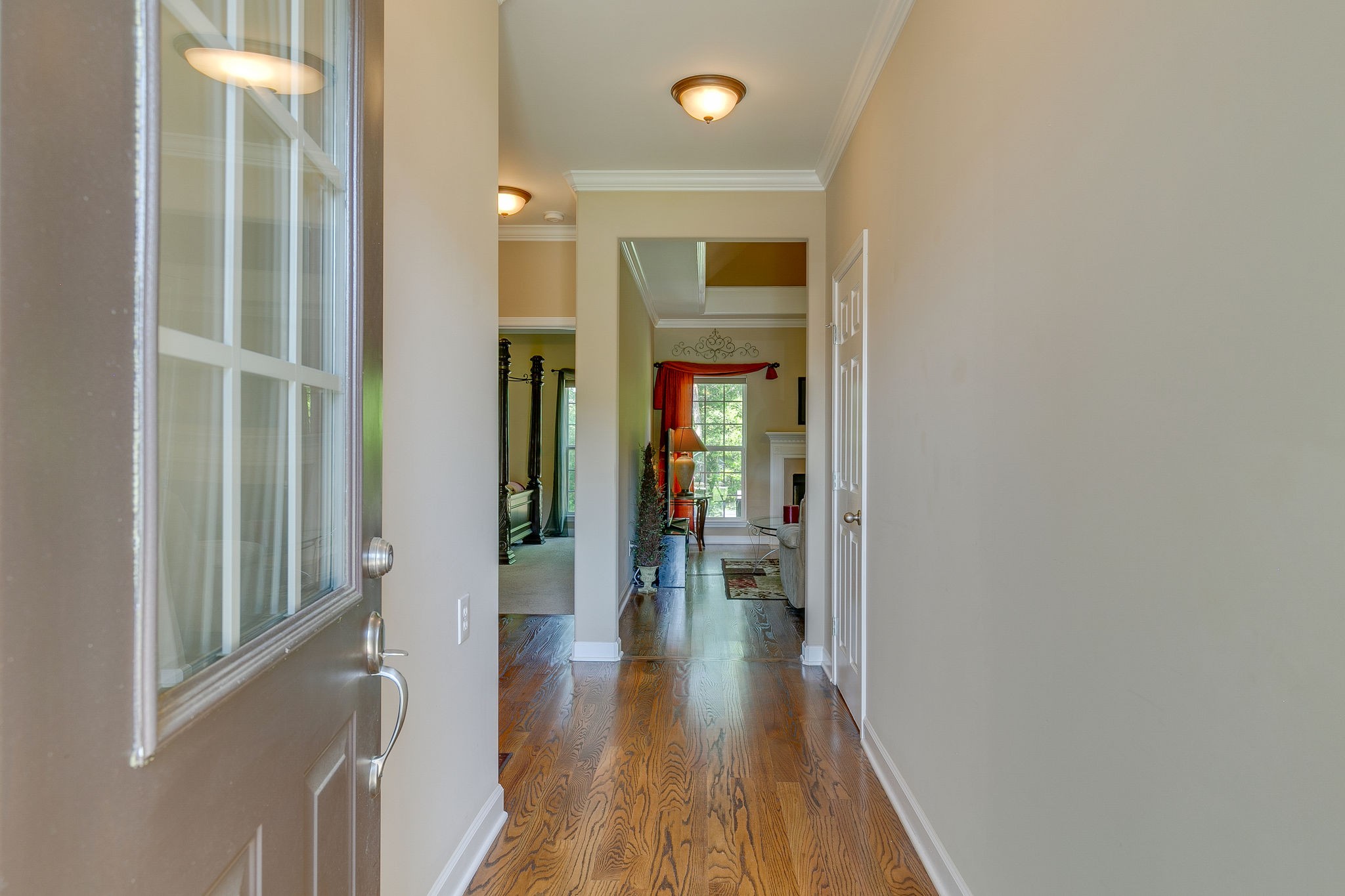1104 Golf View Way Spring Hill, TN 37174 - Photo 3 of 31 a view of a hallway with wooden floor and a living room