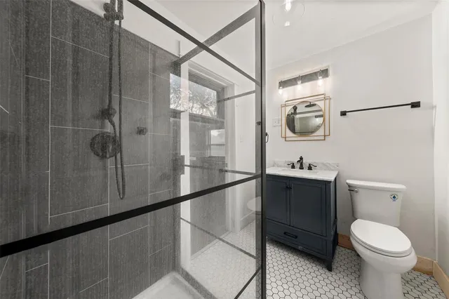 a bathroom with a toilet a sink and shower