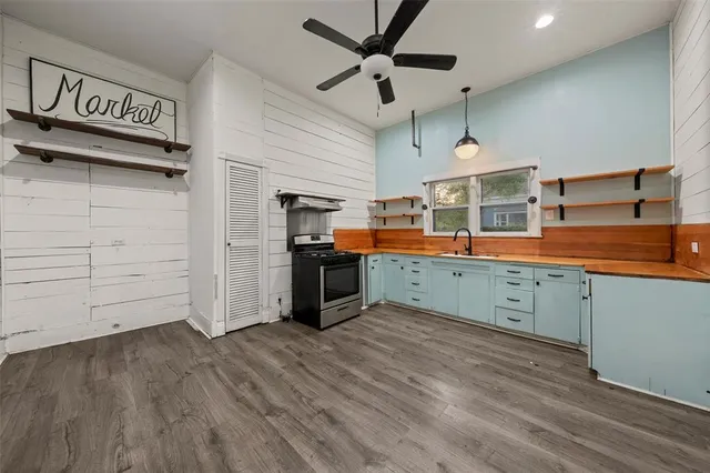 a kitchen with stainless steel appliances kitchen island granite countertop a sink and cabinets