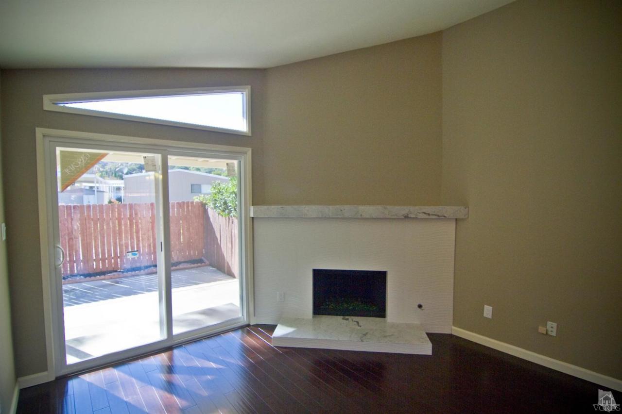 6408 Katherine Road, Unit A Simi Valley, CA 93063 - Photo 3 of 11 a view of empty room with wooden floor and fireplace