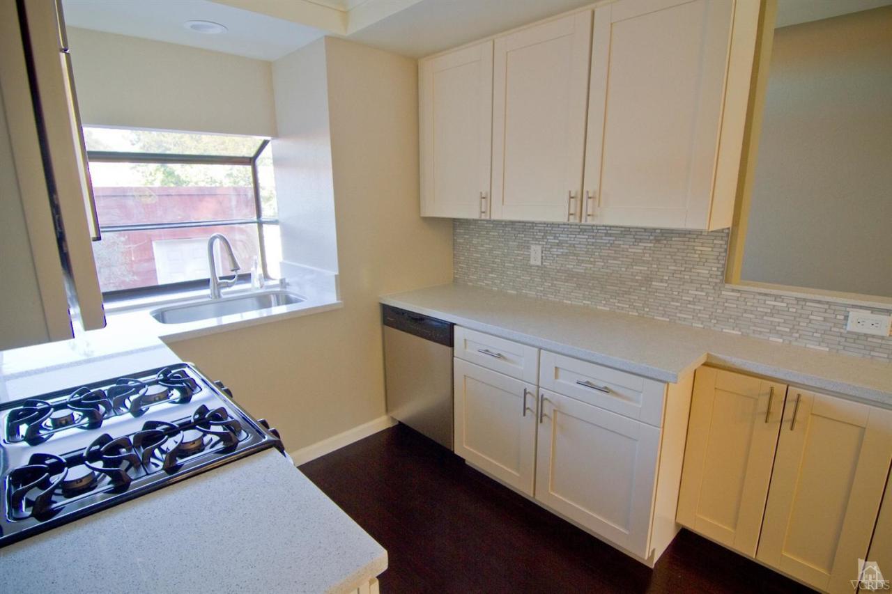 6408 Katherine Road, Unit A Simi Valley, CA 93063 - Photo 7 of 11 a kitchen with stainless steel appliances wooden floor sink and wooden floor