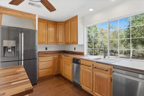 a kitchen with white cabinets and a window