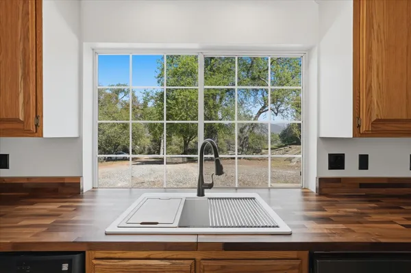 a view of a kitchen counter top space cabinets and windows