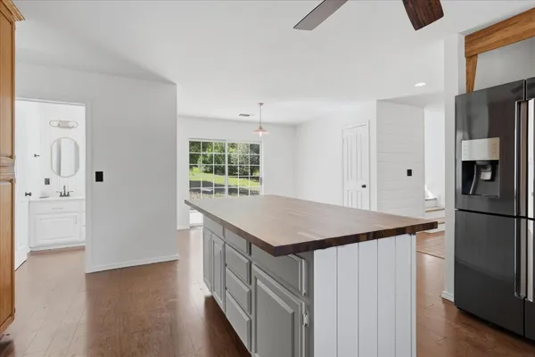 a kitchen with a wooden floor and electronic appliances