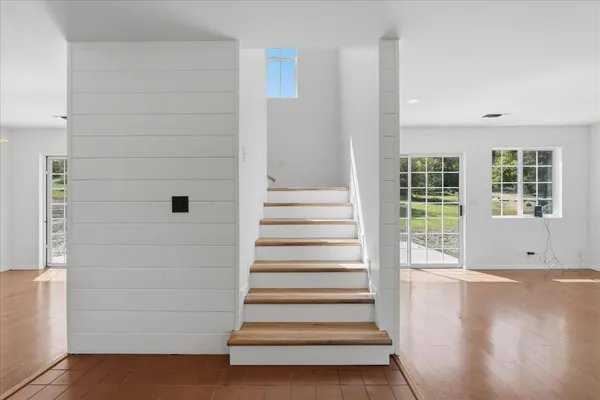a view of entryway with wooden floor and windows