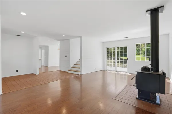 a view of a livingroom with workspace and a window