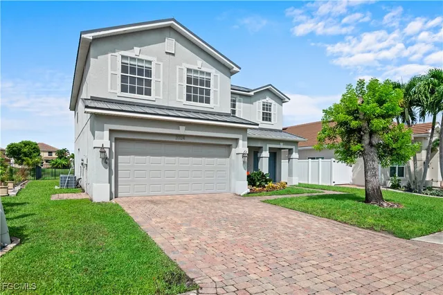 a front view of a house with a yard and garage