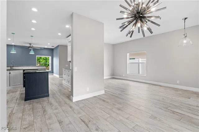 an open kitchen with a sink and a refrigerator