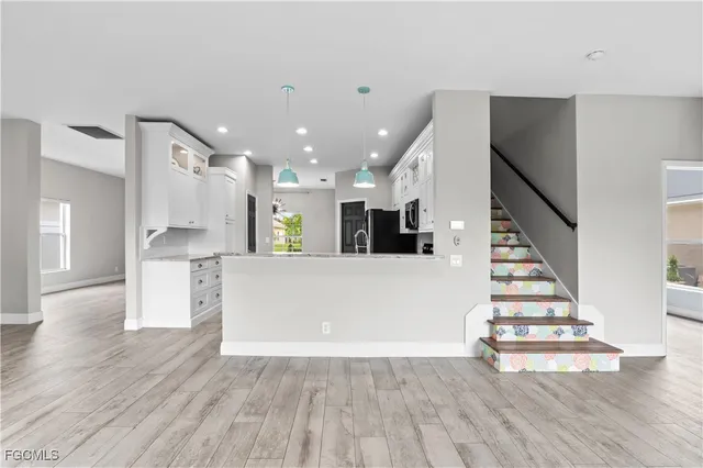 a view of kitchen with furniture and wooden floor