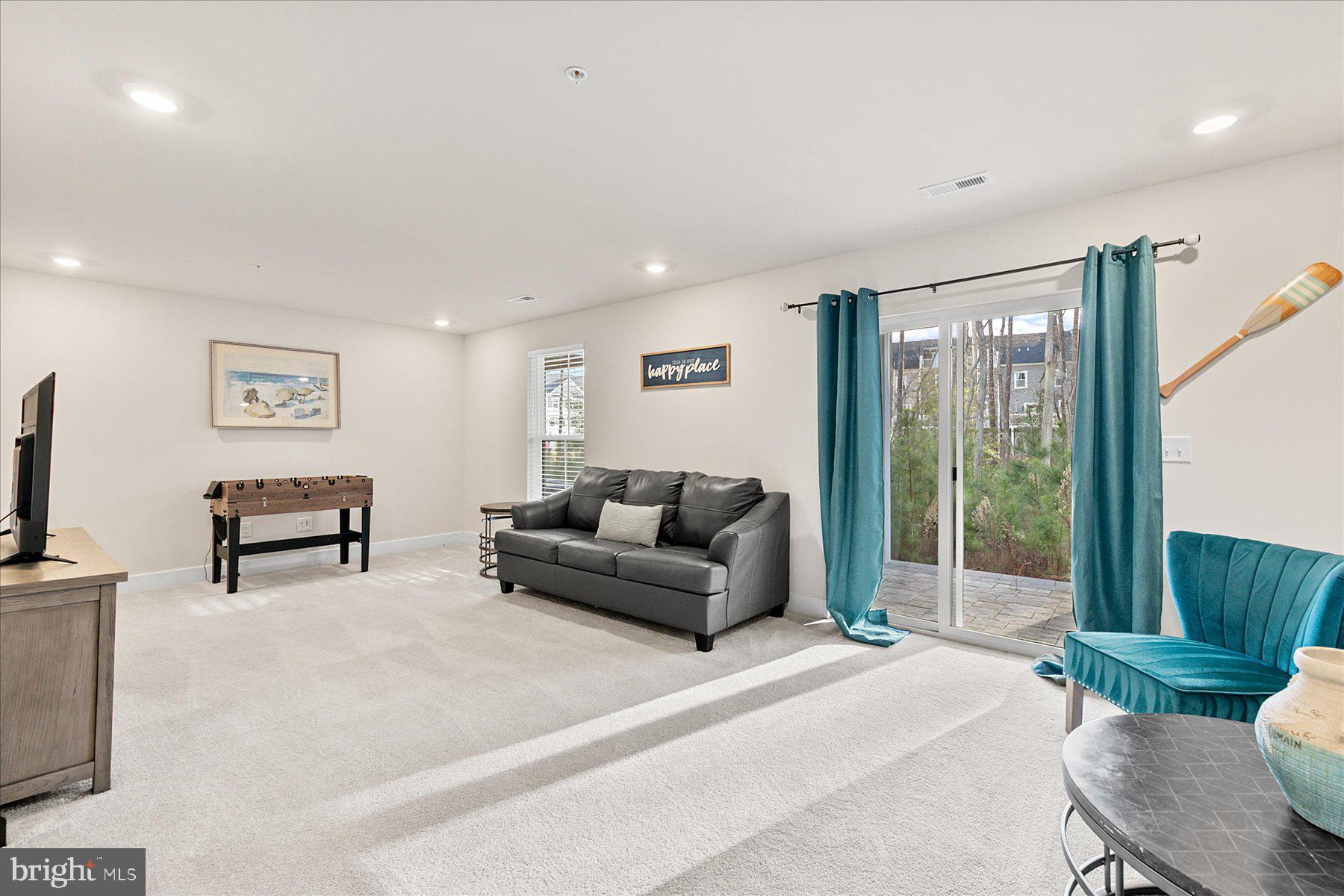 9503 Seascape Lane, Unit 4 Berlin, MD 21811 - Photo 12 of 52 a living room with furniture and a flat screen tv