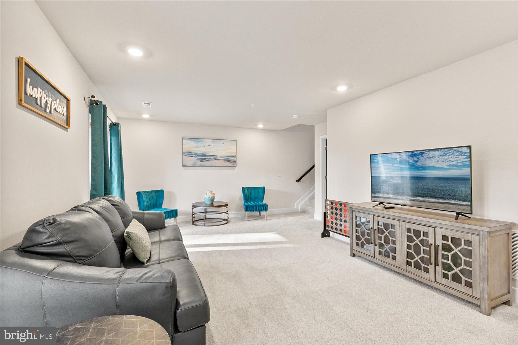 9503 Seascape Lane, Unit 4 Berlin, MD 21811 - Photo 13 of 52 a living room with furniture and a flat screen tv