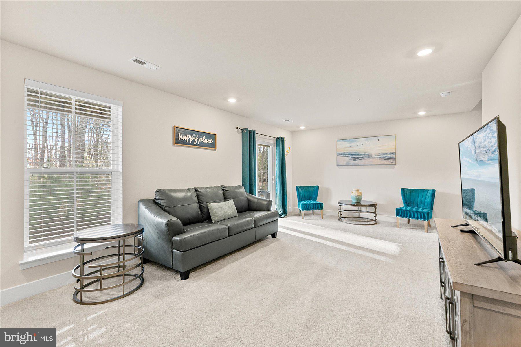 9503 Seascape Lane, Unit 4 Berlin, MD 21811 - Photo 14 of 52 a living room with furniture and a flat screen tv