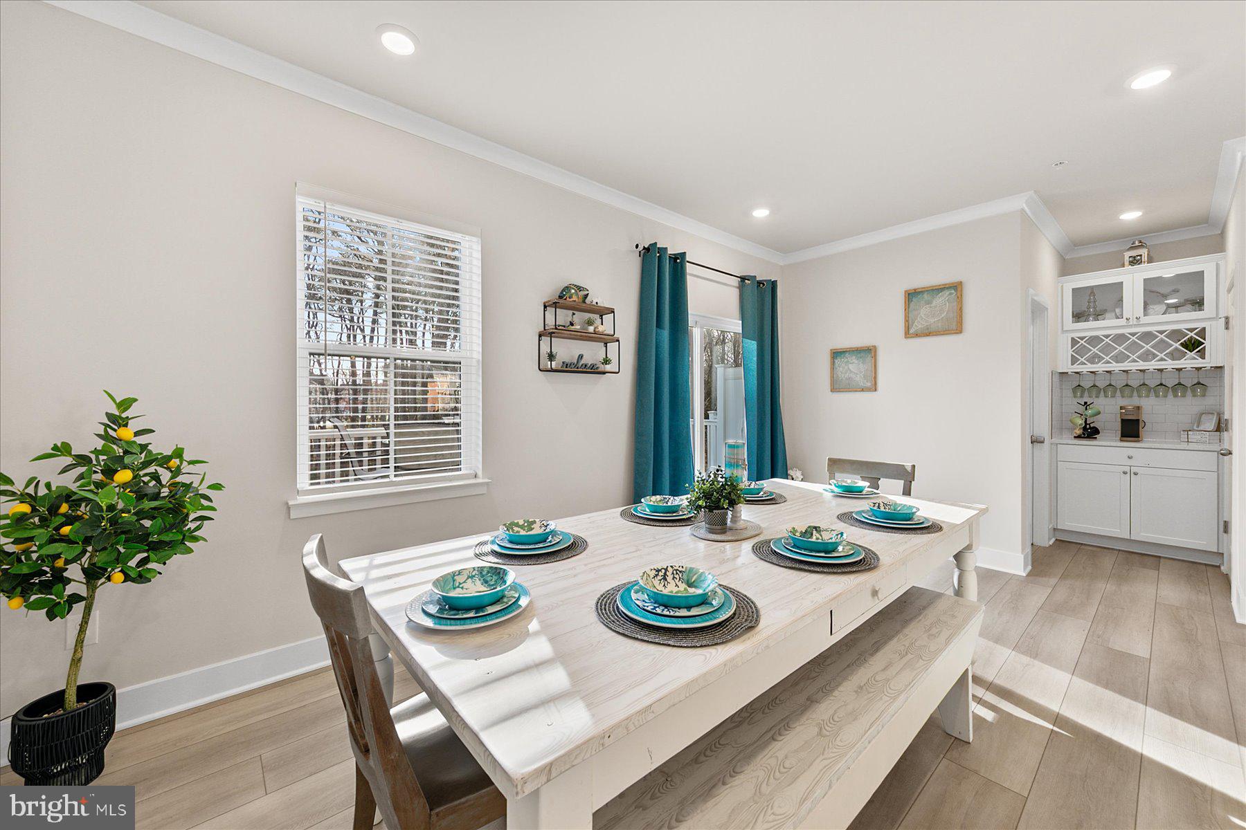 9503 Seascape Lane, Unit 4 Berlin, MD 21811 - Photo 17 of 52 a view of a dining room with furniture window and wooden floor