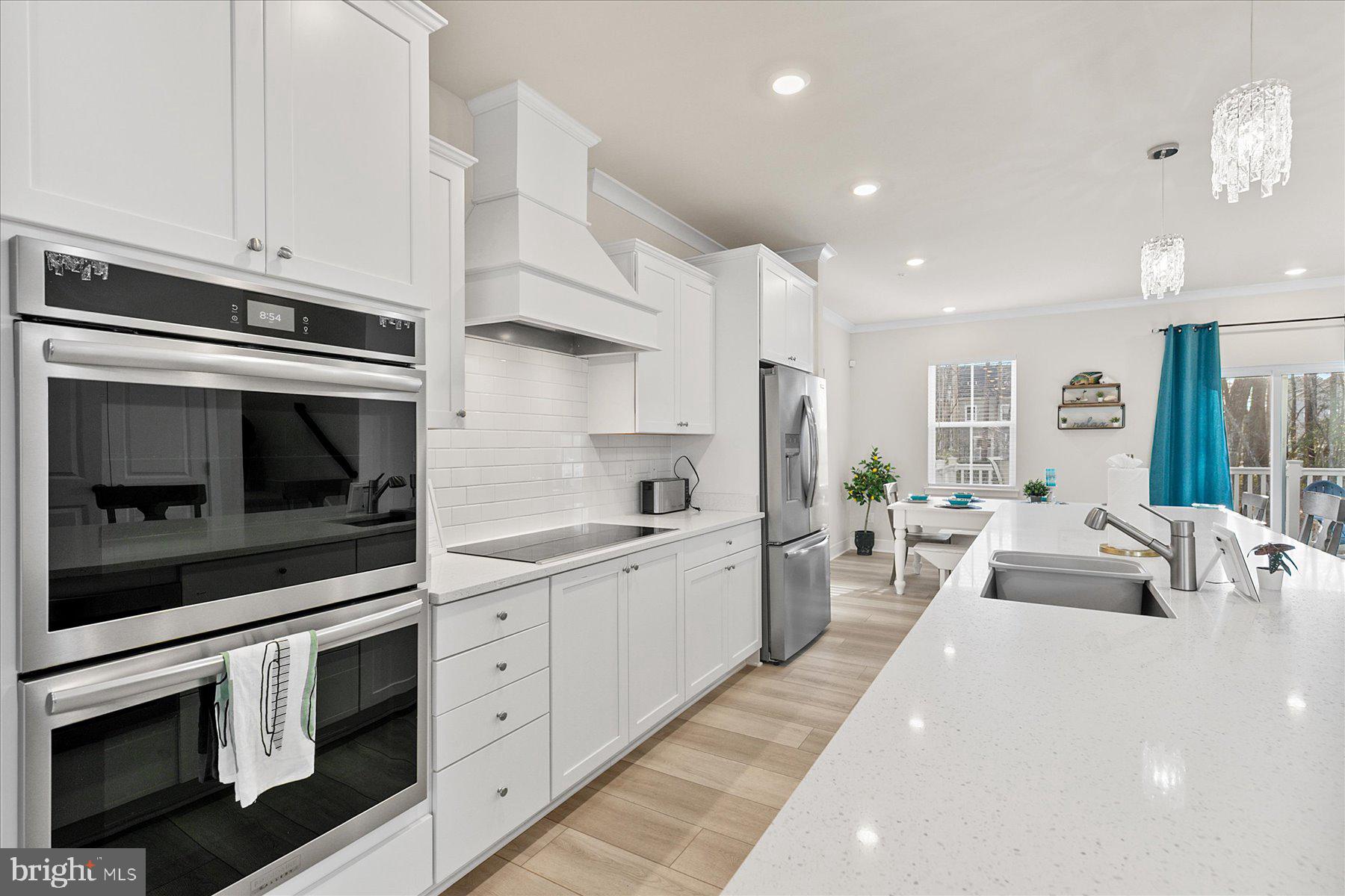 9503 Seascape Lane, Unit 4 Berlin, MD 21811 - Photo 23 of 52 a large white kitchen with stainless steel appliances